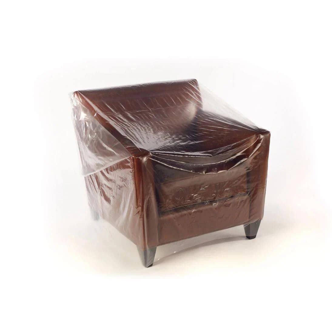 Heavy-duty clear furniture polythene bags covering a sofa for professional moving and storage UK